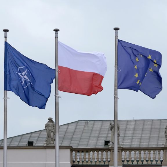The flags of NATO, the EU and Poland are seen next to each other. The flags of NATO, the EU and Poland are seen next to each other.