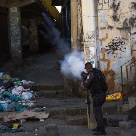 A policeman fires into a building during a protest over the killing of a bystander in Rio de Janeiro during August 2019. A policeman fires into a building during a protest over the killing of a bystander in Rio de Janeiro during August 2019.