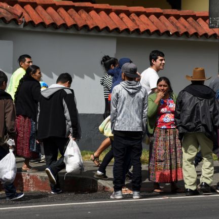 Guatemala is still working out the details of how it will implement a 'safe third country' agreement signed last year with the United States. Migrants deported from the United States stand outside an air force base in Guatemala City on Dec. 12, 2019.