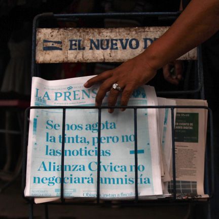 Nicaraguan President Daniel Ortega seems to be going down the same path as his authoritarian predecessors. A passerby picks up a copy of Nicaragua's La Prensa in Managua on March 25, 2019. The newspaper printed its cover in cyan, instead of black, with the headline, 'We are running out of ink, but not of news. The Civic Alliance will not negotiate an amnesty.'