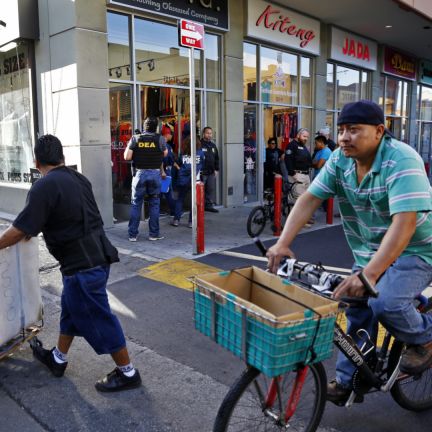 Authorities say drug cartels use businesses, such as this fashion store in Los Angeles, to convert their narcotics profits into pesos. The ability to hide the ownership and origins of ill-gotten gains is crucial to the survival of transnational criminal organizations and terrorist groups. In this photo, authorities raid a fashion storefront in downtown Los Angeles on Sept. 10, 2014, as part of an investigation into the alleged laundering of narcotics profits by Mexican drug cartels.