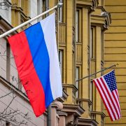 A Russian flag flies next to the U.S. Embassy building in Moscow, Russia, on March 18, 2021.