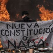 A protester holds a piece of cloth reading "New Constitution or Nothing" during a demonstration in Santiago, Chile, on Oct. 22, 2019. A protester holds a piece of cloth reading "New Constitution or Nothing" during a demonstration in Santiago, Chile, on Oct. 22, 2019.