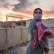 A woman wearing a face mask stands at a terrace on top of a building in Fnideq, Morocco, on Aug. 28, 2020. A woman wearing a face mask stands at a terrace on top of a building in Fnideq, Morocco, on Aug. 28, 2020.