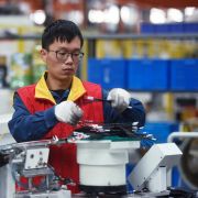 A worker assembles a power distribution cabinet in Hangzhou, China, on Oct. 19, 2020. A worker assembles a power distribution cabinet in Hangzhou, China, on Oct. 19, 2020.