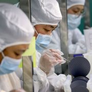 Employees make chips at a semiconductor factory in China's eastern Jiangsu province on March 17, 2021. 