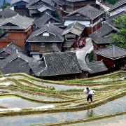 A farmer walks along rice paddy fields in Congjiang, a city located in China's southwestern Guizhou province, on April 24, 2021. 