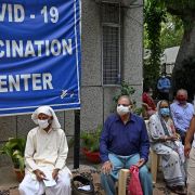 People wait to receive COVID-19 vaccines at a health center in New Delhi on May 13, 2021. 