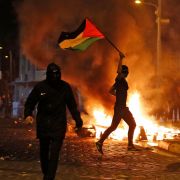 Palestinian protesters hurl stones during clashes with Israeli forces in Israeli-annexed east Jerusalem on May 14, 2021. Palestinian protesters hurl stones during clashes with Israeli forces in Israeli-annexed east Jerusalem on May 14, 2021.