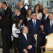Israeli Prime Minster Naftali Bennett (bottom center) talks with members of his new coalition government before posing for a group photo at the President's Residence in Jerusalem on June 14, 2021. Israeli Prime Minster Naftali Bennett (bottom center) talks with members of his new coalition government before posing for a group photo at the President's Residence in Jerusalem on June 14, 2021.