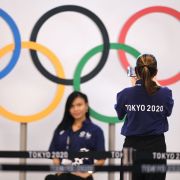 Workers take a picture in front of the Olympic rings at the international airport in Tokyo, Japan, on July 15, 2021. Workers take a picture in front of the Olympic rings at the international airport in Tokyo, Japan, on July 15, 2021.