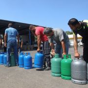 People wait to fill up fuel tanks in the southern Lebanese city of Sidon on Aug. 10, 2021.