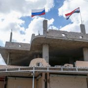 Russian and Syrian flags wave above a damaged building in Syria's southern city of Daraa on Sept. 12, 2021. Russian and Syrian flags wave above a damaged building in Syria's southern city of Daraa on Sept. 12, 2021.