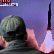A man watches a television showing file footage of a North Korean missile test on Oct. 19, 2021, in Seoul, South Korea. 