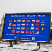 The flags of NATO member countries are seen on a billboard in Riga, Latvia, on Nov. 28, 2021, two days before the start of meetings to discuss Russia’s military buildup near Ukraine. 