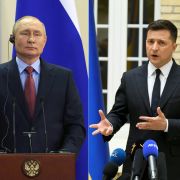 A combination of photos created on Jan. 11, 2022, shows Russian President Vladimir Putin (left) and Ukrainian President Volodymyr Zelensky (right) at separate press conferences. 