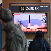 People at a railway station in Seoul, South Korea, watch a television screen showing file footage of a North Korean missile test on Jan. 17, 2022. 