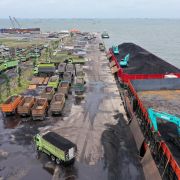 Machinery is used to load coal onto trucks at a port in Jakarta, Indonesia, on Jan. 17, 2022. 
