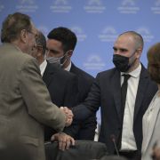 Argentina's finance minister Martin Guzman (center) shakes hands with a member of the country’s Congress in Buenos Aires before briefing legislators on the government’s new deal with the International Monetary Fund on March 7, 2022. 