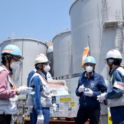 Director General of the International Atomic Energy Agency (IAEA) Rafael Grossi (second from the right) stands in front of the storage tanks for radioactive water as he visits the Tokyo Electric Power Company Holdings (TEPCO) Fukushima Daiichi nuclear power plant in Okuma, Japan, on May 19, 2022. 