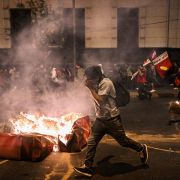 Supporters of former Peruvian President Pedro Castillo clash with riot police in Lima on Dec. 11, 2022, during a demonstration demanding Castillo's release and early legislative elections. Supporters of former Peruvian President Pedro Castillo clash with riot police in Lima on Dec. 11, 2022, during a demonstration demanding Castillo's release and early legislative elections.