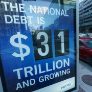 A sign at a bus shelter shows the national debt in Washington, D.C., on Jan. 20, 2023.