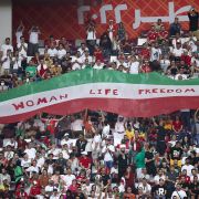Iranian soccer fans hold up a ''Woman Life Freedom'' sign in solidarity with the protests at home during Iran's match with England at the World Cup in Doha, Qatar, on Nov. 21, 2022. Iranian soccer fans hold up a ''Woman Life Freedom'' sign in solidarity with the protests at home during Iran's match with England at the World Cup in Doha, Qatar, on Nov. 21, 2022.