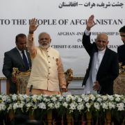 Indian Prime Minister Narendra Modi (left) and then-Afghan President Ashraf Ghani wave during the inauguration of the Afghan-India Friendship Dam in Herat, Afghanistan, on June 4, 2016. 