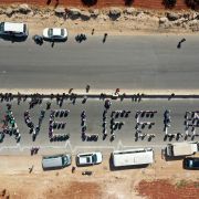 Civilians and humanitarian workers form a human chain calling for the continuation of U.N.-authorized aid near Syria’s Bab al-Hawa border crossing with Turkey. 