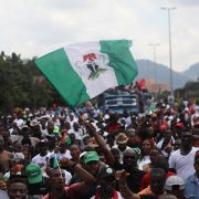 The Nigerian flag is waved above a crowd at a political rally for Labor Party candidate Peter Obi in Abuja, Nigeria, on Sept. 24, 2022. The Nigerian flag is waved above a crowd at a political rally for Labor Party candidate Peter Obi in Abuja, Nigeria, on Sept. 24, 2022.