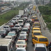 A line of cars seeking to fill up at a gas station extends down a four-lane road in Lagos, Nigeria, on Feb. 9, 2022. 