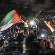 People in Gaza City wave the Palestinian flag in celebration of the cease-fire reached between Israel and Hamas on May 21, 2021. People in Gaza City wave the Palestinian flag in celebration of the cease-fire reached between Israel and Hamas on May 21, 2021.