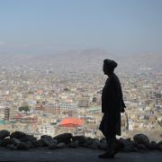 An Afghan man walks along a hilltop overlooking Kabul on March 21, 2018.