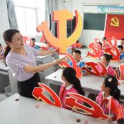 A teacher and her students hold Chinese Communist Party emblems during a lesson about the party’s history in Lianyungang, China, on June 28, 2020. A teacher and her students hold Chinese Communist Party emblems during a lesson about the party’s history in Lianyungang, China, on June 28, 2020.