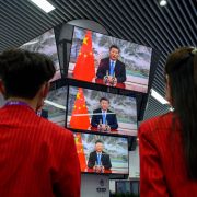 People watch Chinese President Xi Jinping speak during the opening ceremony of the China International Import Expo on Nov. 4, 2021, in Shanghai.