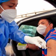 A man receives a dose of a COVID-19 vaccine at a drive-through distribution site in Bogota, Colombia, on April 11, 2021. A man receives a dose of a COVID-19 vaccine at a drive-through distribution site in Bogota, Colombia, on April 11, 2021.