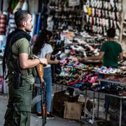 A member of the Kurdish Internal Security Police Force of Asayish stands guard at a market in the northeastern Syrian city of Qamishli on Aug. 5, 2019.