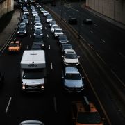 This image shows vehicles traveling through Brooklyn. The White House will decide soon whether to claim the power to impose tariffs on auto imports it deems unfair.