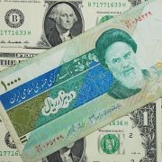 This photo shows 10,000 Iranian rials on top of U.S. dollars.