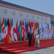 Officials stand near flags of participating countries and organizations at the venue where the second meeting of the G-20 Finance and Central Bank Deputies under India's G-20 presidency has begun Feb. 22, 2023, in Bengaluru, India.