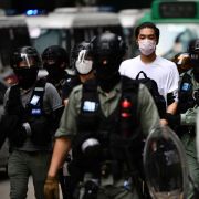 A man is detained by riot police in downtown Hong Kong during a pro-democracy demonstration on May 27, 2020. A man is detained by riot police in downtown Hong Kong during a pro-democracy demonstration on May 27, 2020.