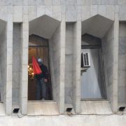 A protester is seen in the window of the seized main government building, known as the White House, in Bishkek, Kyrgyzstan, on Oct. 6, 2020. A protester is seen in the window of the seized main government building, known as the White House, in Bishkek, Kyrgyzstan, on Oct. 6, 2020.