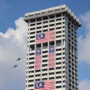 Royal Malaysian Air Force helicopters fly past a building during the 65th National Day parade at Independence Square on Aug. 31, 2022, in Kuala Lumpur, Malaysia. 