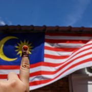 A voter shows a fading inked finger from casting a vote during Malaysia's Nov. 19 general election on Nov. 22, 2022, in Petaling Jaya, Malaysia.