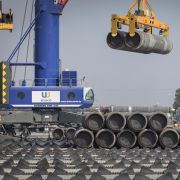 A crane moves Nord Stream 2 pipes at a port near Sassnitz, Germany, on June 5, 2019. A crane moves Nord Stream 2 pipes at a port near Sassnitz, Germany, on June 5, 2019.
