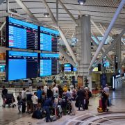 Passengers wait to check in for one of the last international flights out of Cape Town, South Africa, after countries began imposing travel bans to contain the spread of the new Omicron COVID-19 variant on Nov. 29, 2021. Passengers wait to check in for one of the last international flights out of Cape Town, South Africa, after countries began imposing travel bans to contain the spread of the new Omicron COVID-19 variant on Nov. 29, 2021.