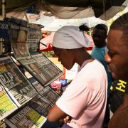 People read newspapers announcing the death of Tanzanian President John Magufuli in Dar es Salaam on March 18, 2021. People read newspapers announcing the death of Tanzanian President John Magufuli in Dar es Salaam on March 18, 2021.