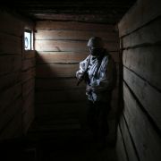 A Ukrainian serviceman is seen in a dugout in the Donetsk region of eastern Ukraine on Feb. 2, 2022. 