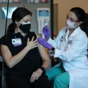 A pharmacist receives her first dose of the Pfizer COVID-19 vaccine in Miramar, Florida, on Dec. 14, 2020. A pharmacist receives her first dose of the Pfizer COVID-19 vaccine in Miramar, Florida, on Dec. 14, 2020.