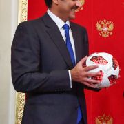 Qatari Emir Sheikh Tamim bin Hamad al-Thani (L) smiles at FIFA President Gianni Infantino (C) and Russian President Vladimir Putin at the end of the 2018 World Cup in Russia.